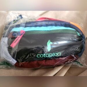 Cotopaxi Kapai 1.5L Hip Pack - Multicolor (representative stock photos included)